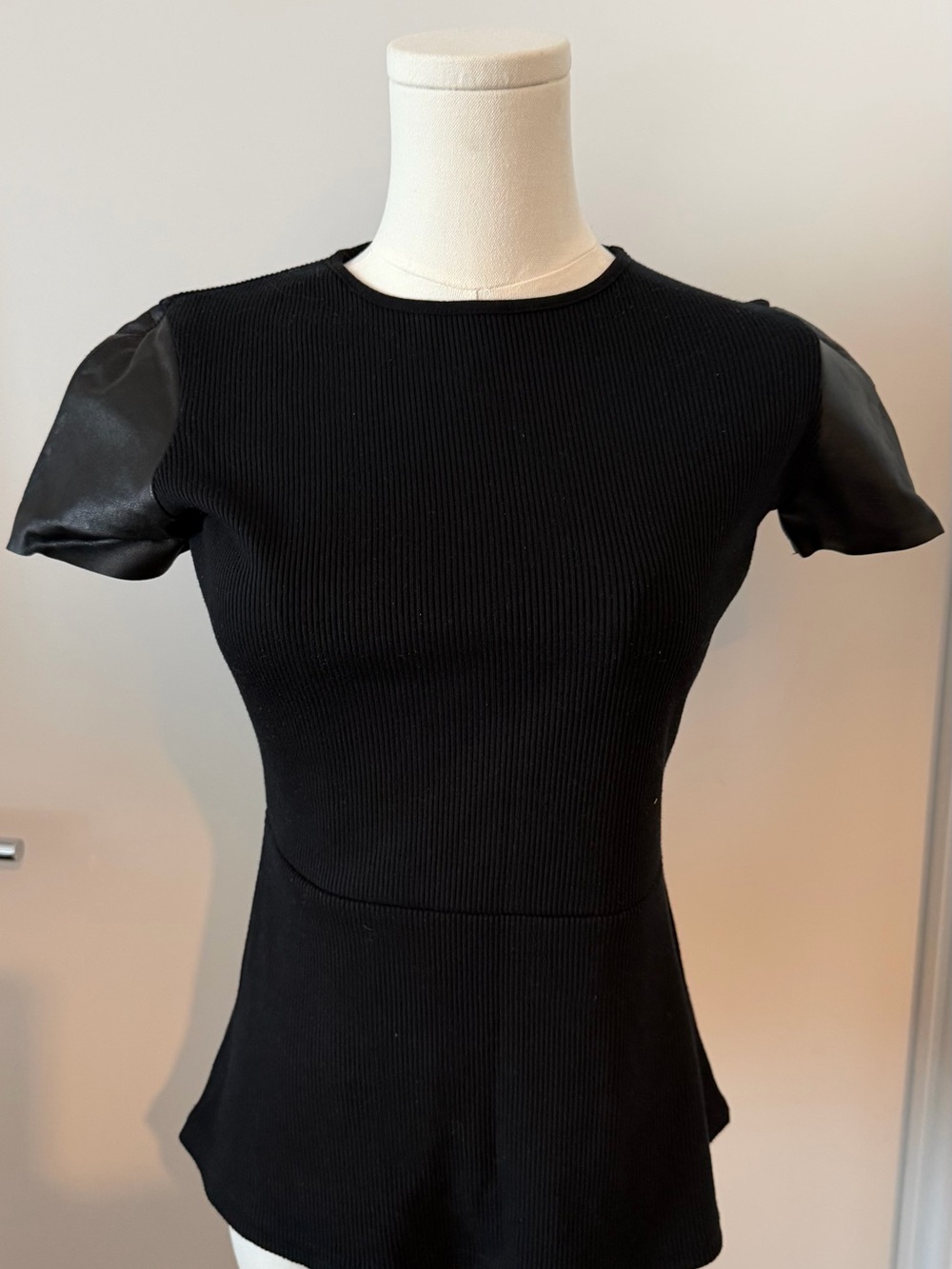 Maggie Ward Black Ribbed Peplum Top with Faux-Leather Sleeves – Size XS